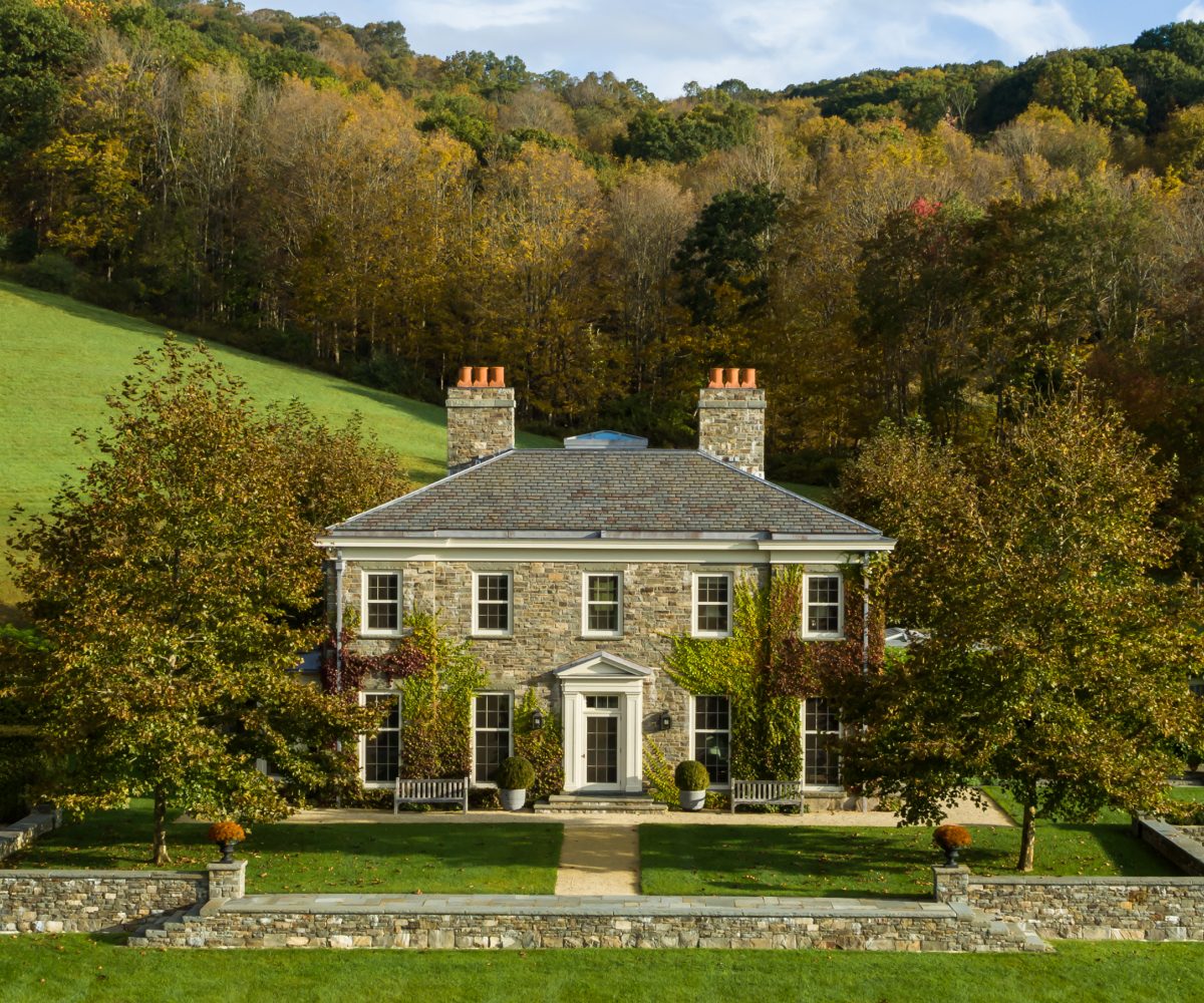 Exterior image of fieldstone-clad Dutchess County New York Regency-style home by Gil Schafer III in his new book Home at Last: Enduring Design for the New American Home Rizzoli publisher written with Mark Kristal