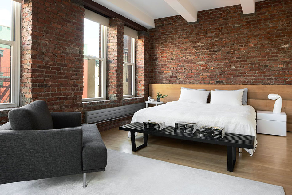 The bedroom, featuring a cedar headboard, in the Chinatown loft