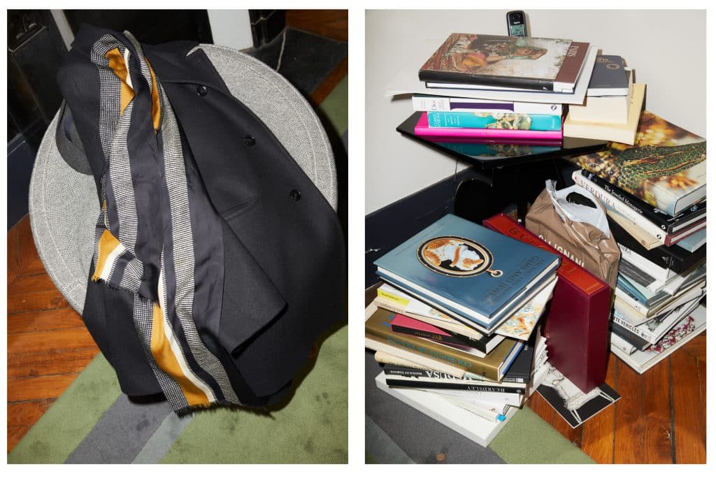 At left, Elie Top's jacket draped on a chair by Vincent Darré. At right, part of the designer's collection of jewelry books.