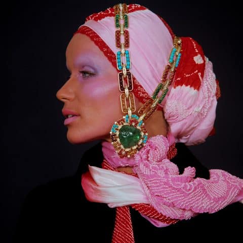 Bulgari sautoir/bracelets combination in gold with emeralds, rubies, amethysts, citrines, topazes, turquoise and diamonds is draped over model Veruschka in this photo from the March 1970 issue of Vogue