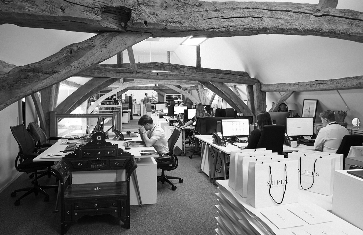 Xupes employees work in the upper office of the UK head office, a 17th-century barn in Bishops Stortford, Hertfordshire