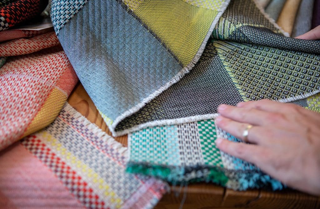 This story's author touches samples of Jongerius's fabrics in various colorways.