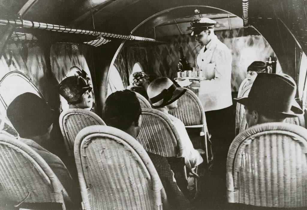 In a black-and-white photo from the book Rattan: A World of Elegance and Charm, by Lulu Lytle, published by Rizzoli, passengers sit in rattan seats on an airline flight circa 1930.