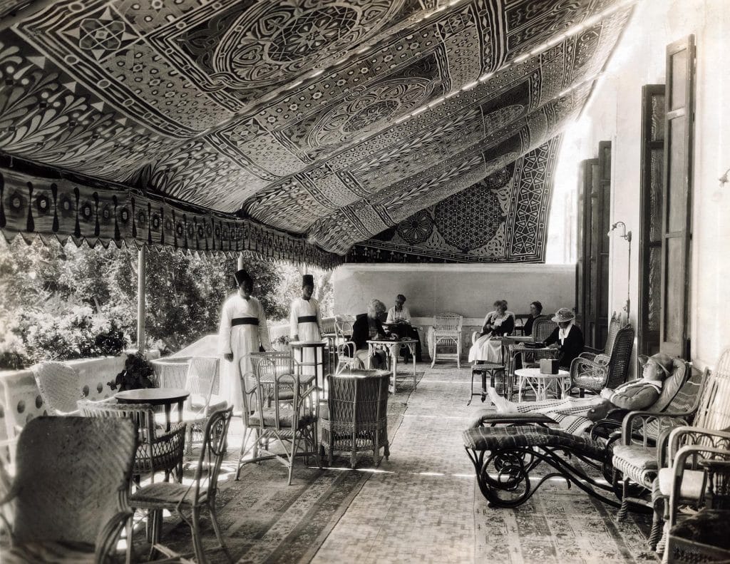 In a black-and-white photo from the book Rattan: A World of Elegance and Charm, by Lulu Lytle, published by Rizzoli, rattan furniture fills the veranda of the Helouhan Hotel, near Cairo