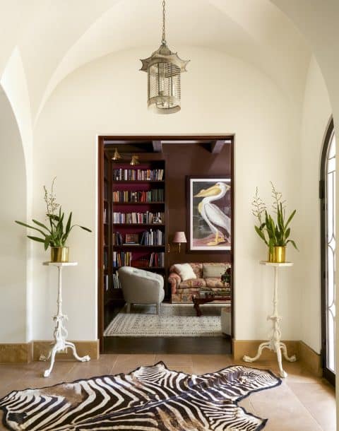 A pair of Chippendale candlestands flanking the entrance to the library of a home in Austin, Texas, from the book Markham Roberts: Notes on Decorating