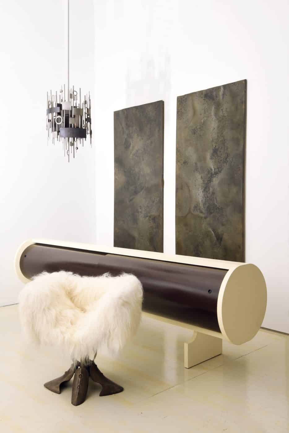 An Alain Douillard pendant, a pair of wall panels by Pierre Sabatier, a Jean-Louis Chanéac sideboard and a 1970s or '80s goatskin chair at Magen H Gallery's 2019 show “50 Years of French Design”