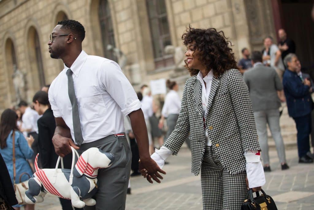 Dwyane Wade, hand in hand with Gabrielle Union, carries Thom Browne's Hector bag outside the designer's Paris runway show in 2017.