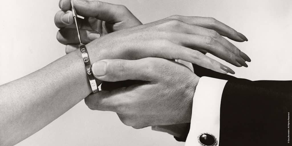 Aldo Cipullo demonstrates how to attach the Cartier Love bracelet using the screwdriver that comes with each one