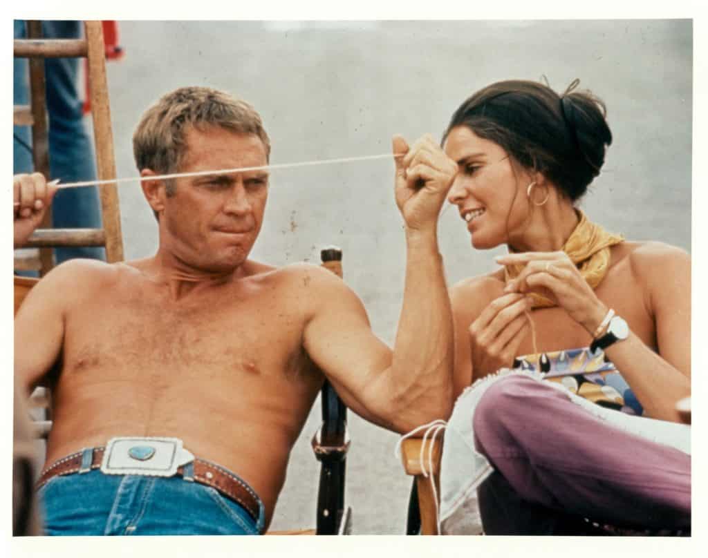 Ali MacGraw, right, wears the Love bracelet while sitting with Steve McQueen on the set of their 1972 film The Getaway.