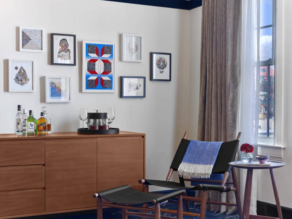 A grouping of works by Kelly Kozma, Hilary White, Alex Eckman-Lawn, Courtney Brown and Jason Andrew Turner adorns a guest room at Hotel Revival Baltimore. 
