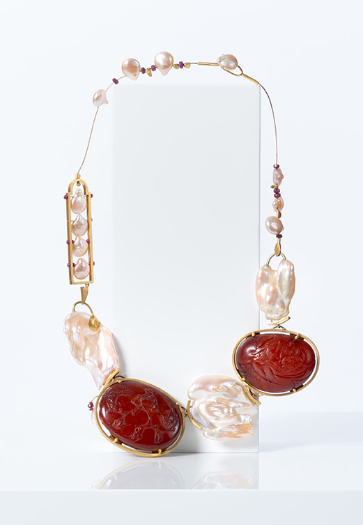 A Mimi Lipton necklace of Baltic amber carved in 18th-century China as well as baroque pearls, offered by Objet d'Emotion