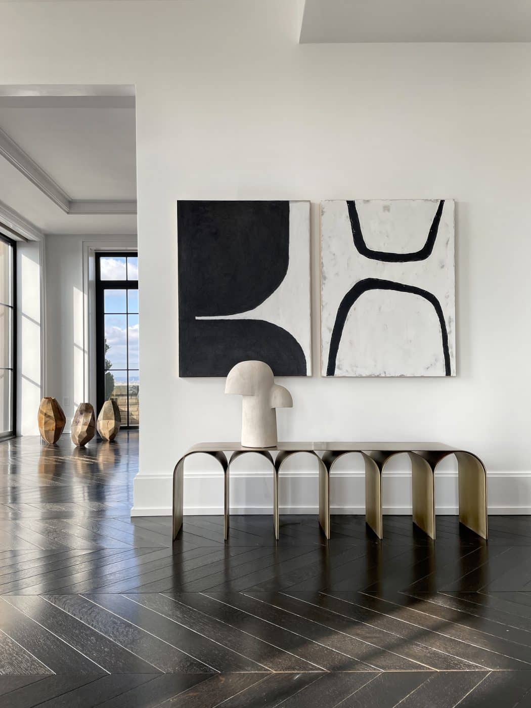 Pietro Franceschini's brass Gold Arch bench in the living room area of Galerie Philia's staged apartment in New York's Walker Tower