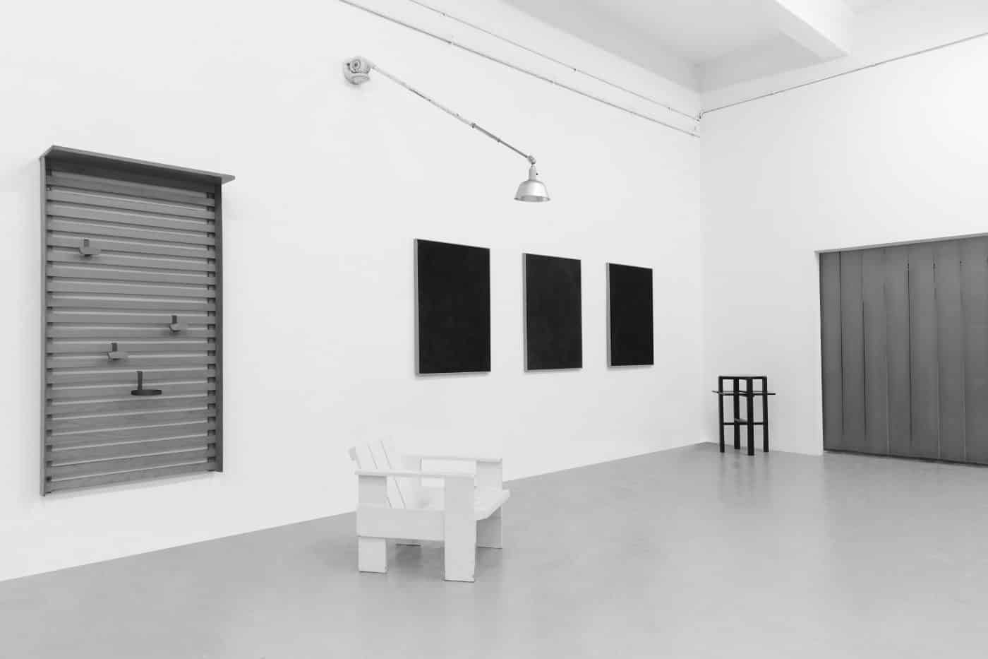 A black-and-white photo of DADA Studios' first exhibition, in October 2016.