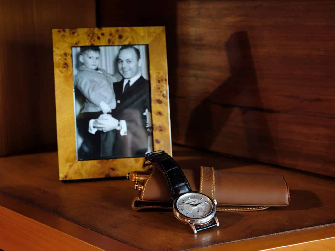 A picture of Todd Levin at three years old with his father sits alongside his father's Montblanc 18 karat yellow gold fountain and ballpoint pens and a Philippe Dufour Simplicity watch with a platinum case with guilloché dial