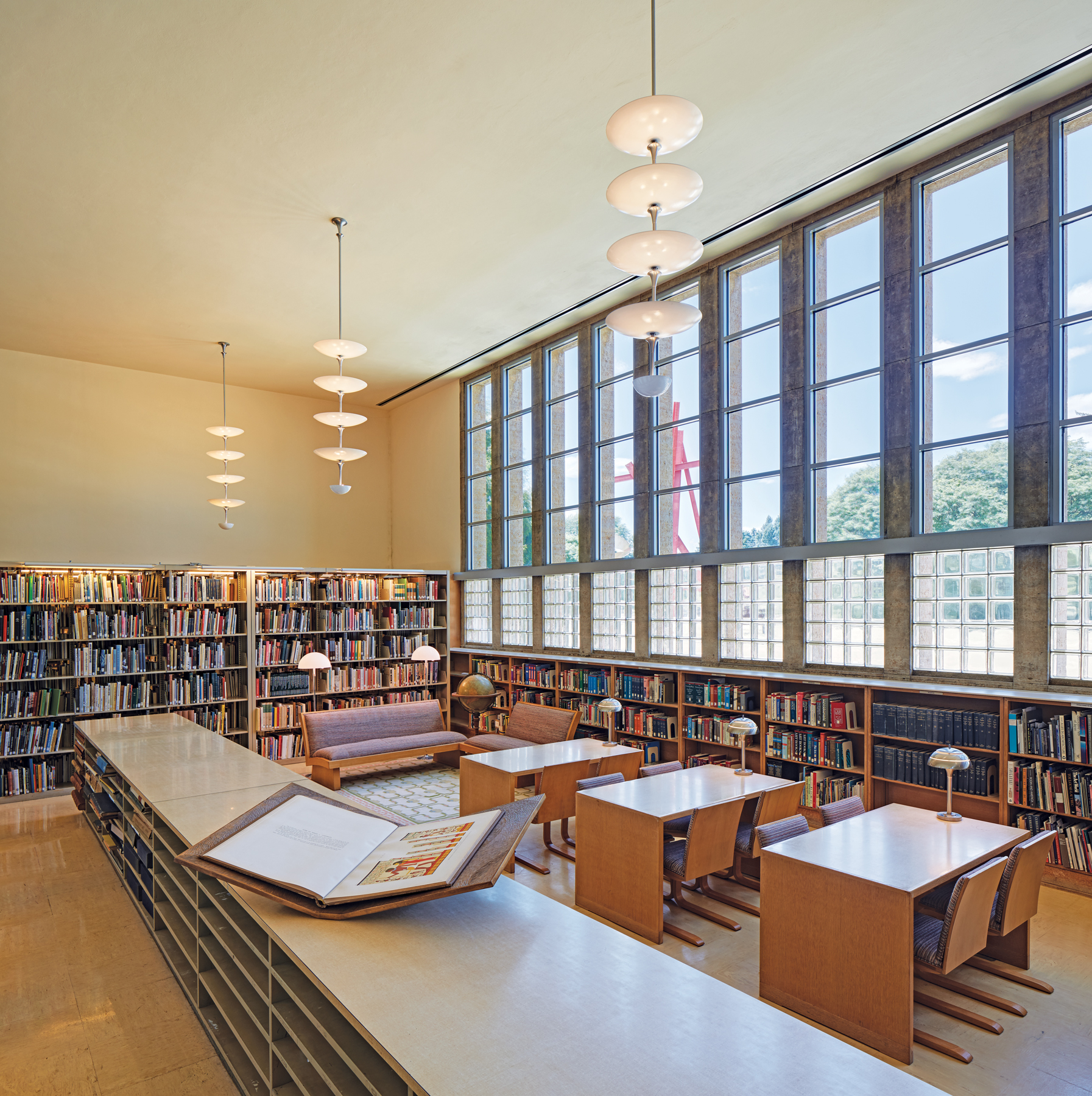 interior of Cranbrook Academy of Art Library, featuring tiered light fixtures and shelves of books