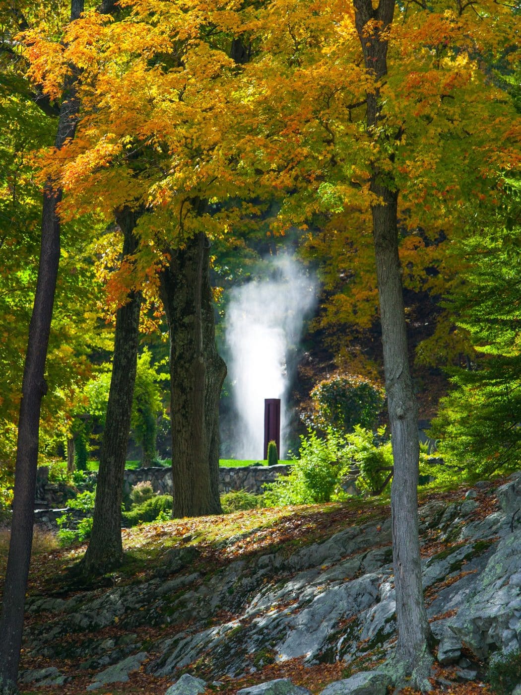 Innisfree garden with a water sculpture through the trees