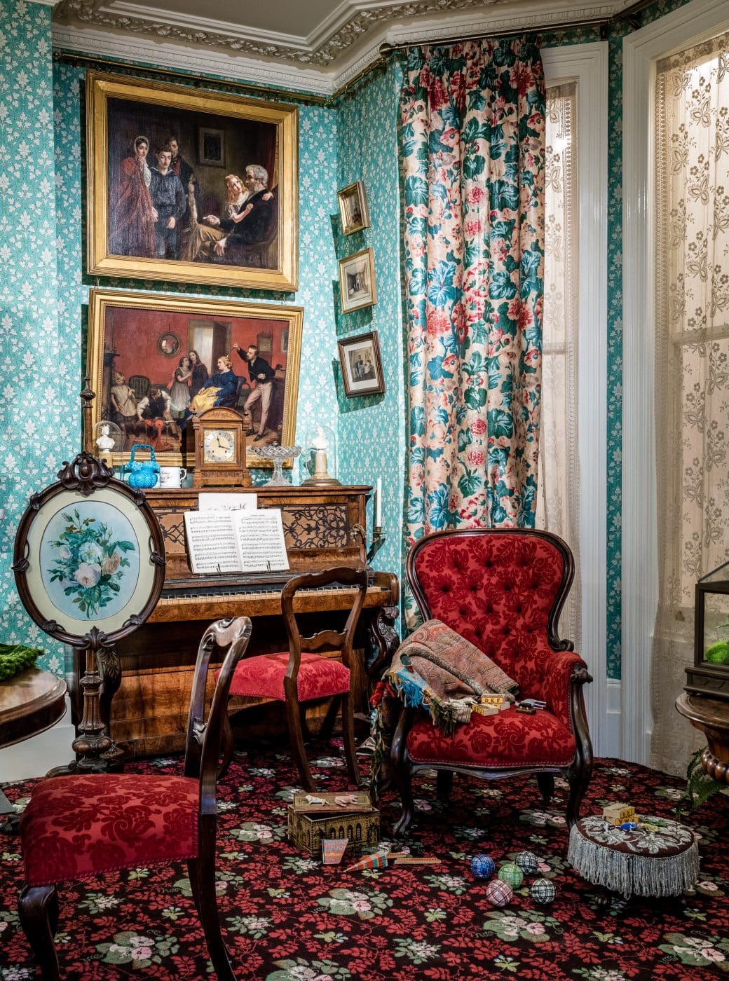 An 1870 parlor with a piano and an ornate armchair