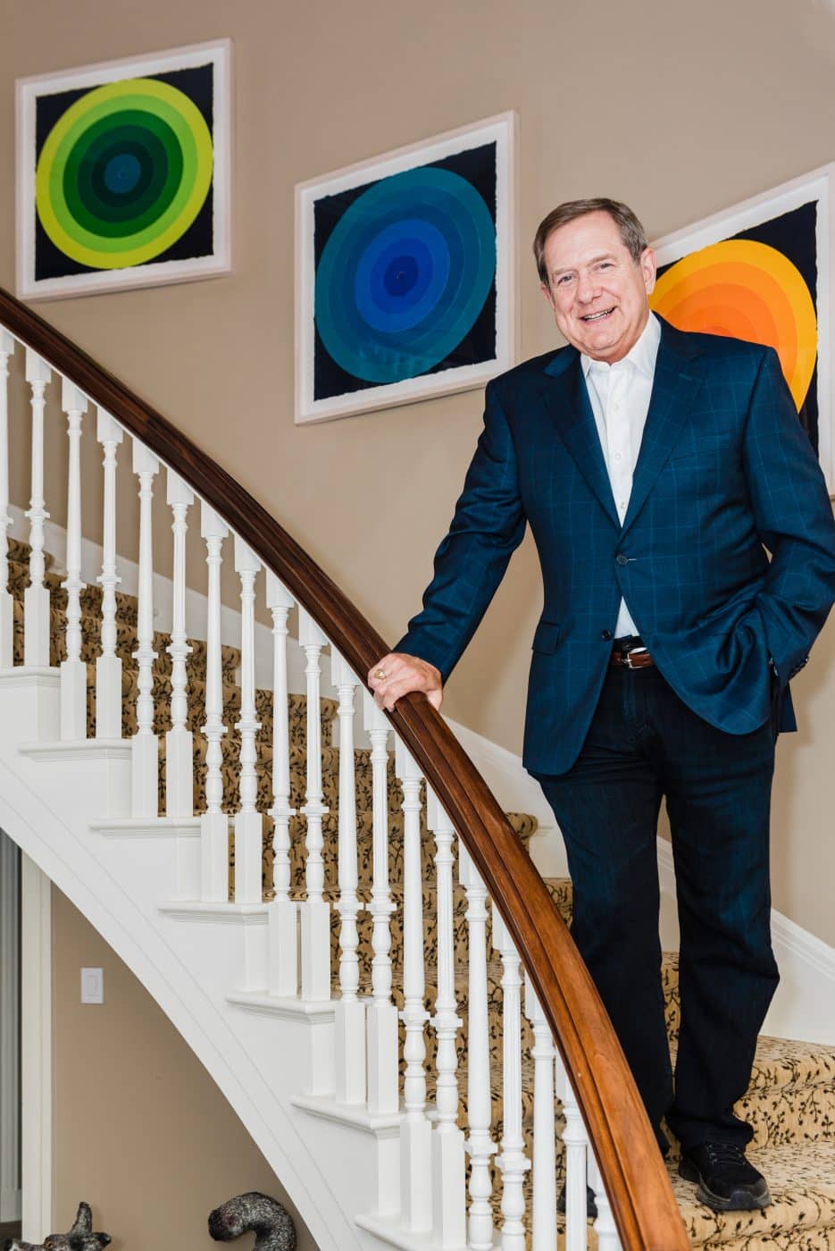 Jordan Schnitzer's home in Portland, Oregon: Schnitzer on his staircase with On Target, 2019, by Polly Apfelbaum