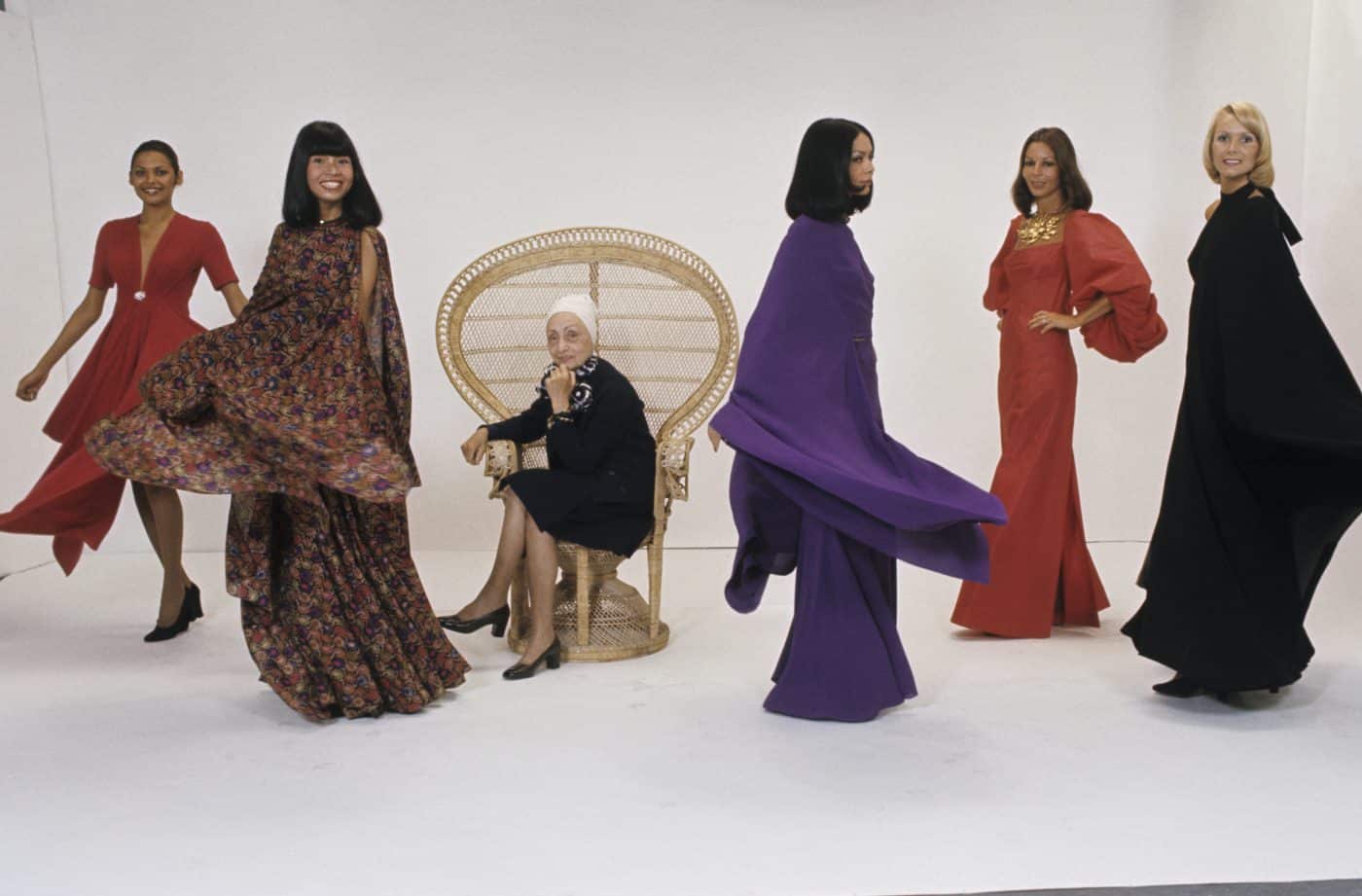 photo of Madame Grès at her Paris boutique amongst models wearing her designs