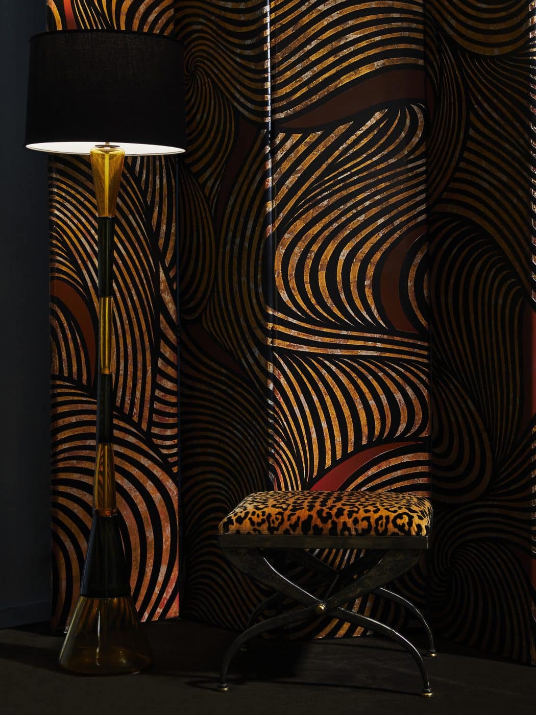 Springer's 1986 lacquer Coromandel screen makes an ideal backdrop for a circa 1960 hand-blown-glass Venini floor lamp and a 1970s leopard-print bench.