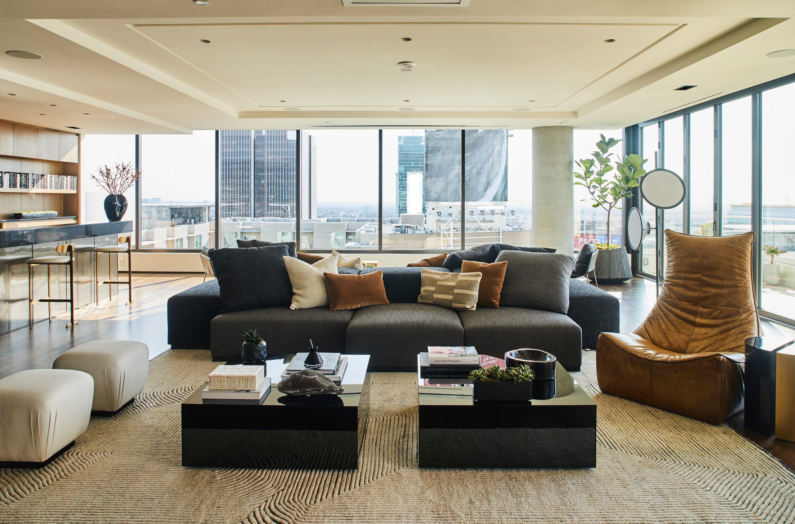 In another L.A. penthouse, Smith outfitted the living room with a custom two-sided sofa and, from 1stDibs, a Gerard van der Berg Rock Chair and a pair of ottomans.