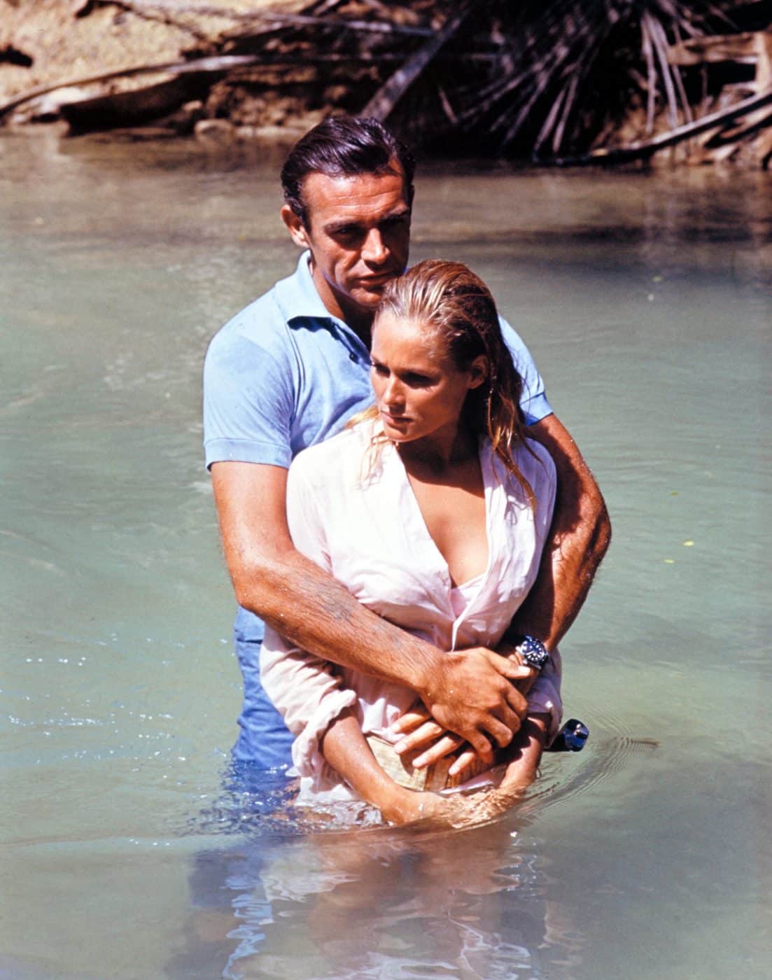 Photo of the original James Bond, Sean Connery, in a scene with Ursula Andress in the 1962 film Dr. No.