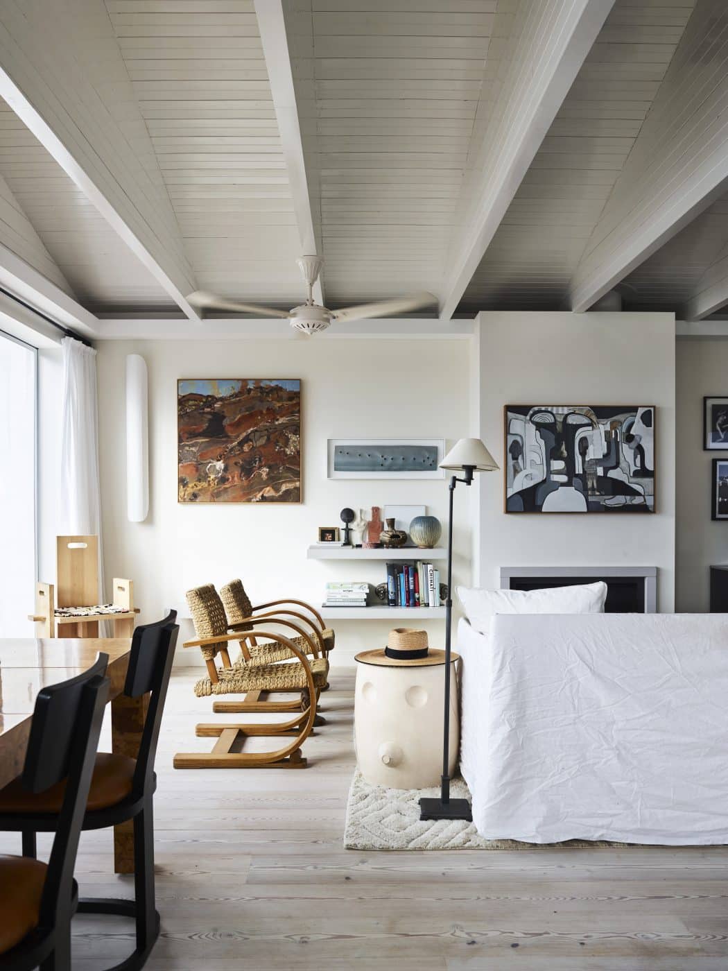 Fireplace area with art decorating the wall above