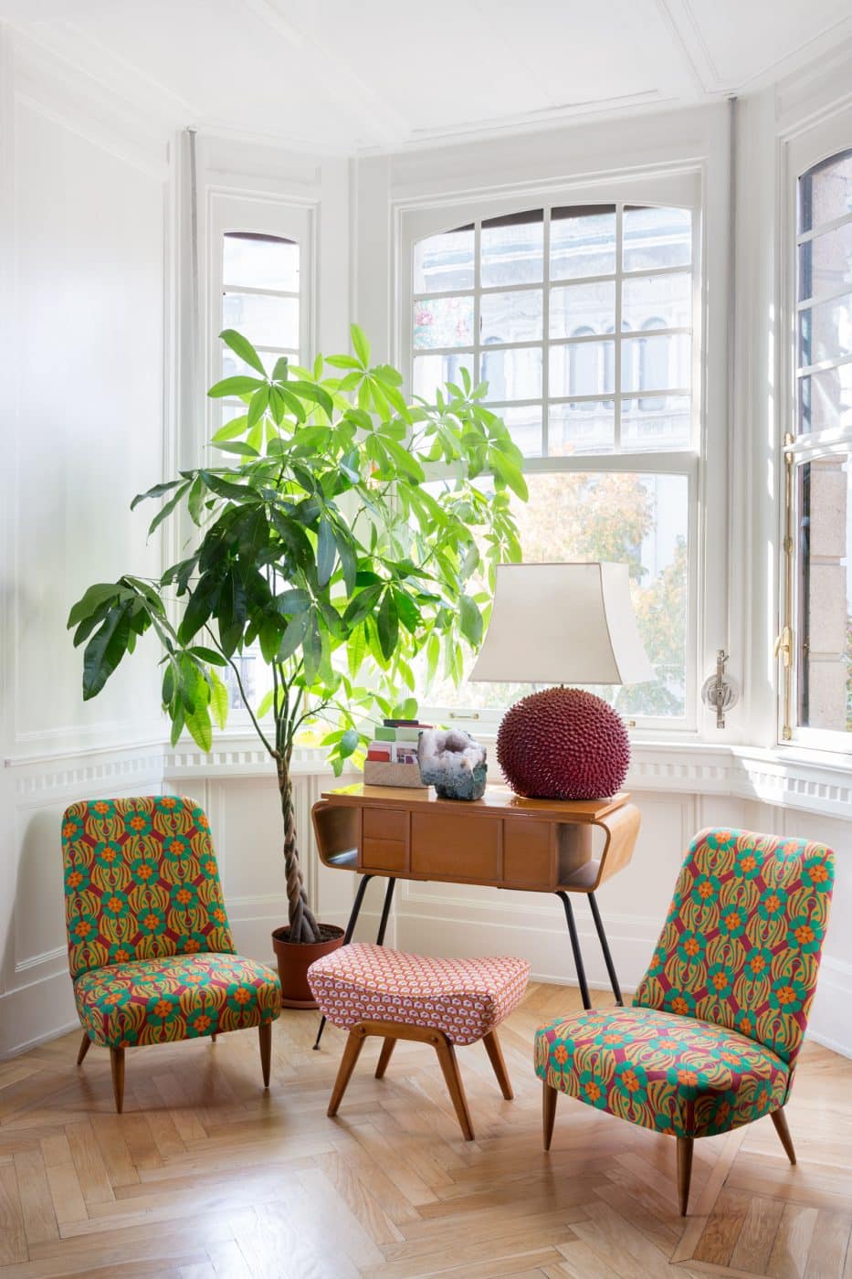 Seating area featuring vintage furniture reupholstered in La DoubleJ Cubi prints: A pair of 1950s CHAIRS flank a 1970s POGGIAPIEDI, or footstool.