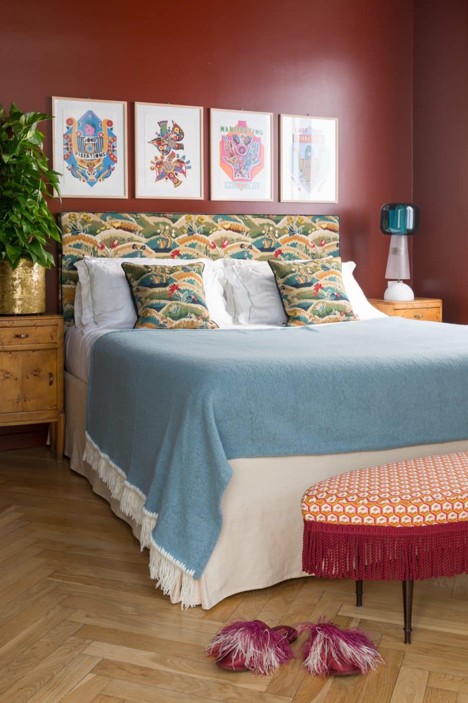 Martin's bedroom features a 1950s OVAL BENCH covered in her geometric Cubi print with a fringe border.