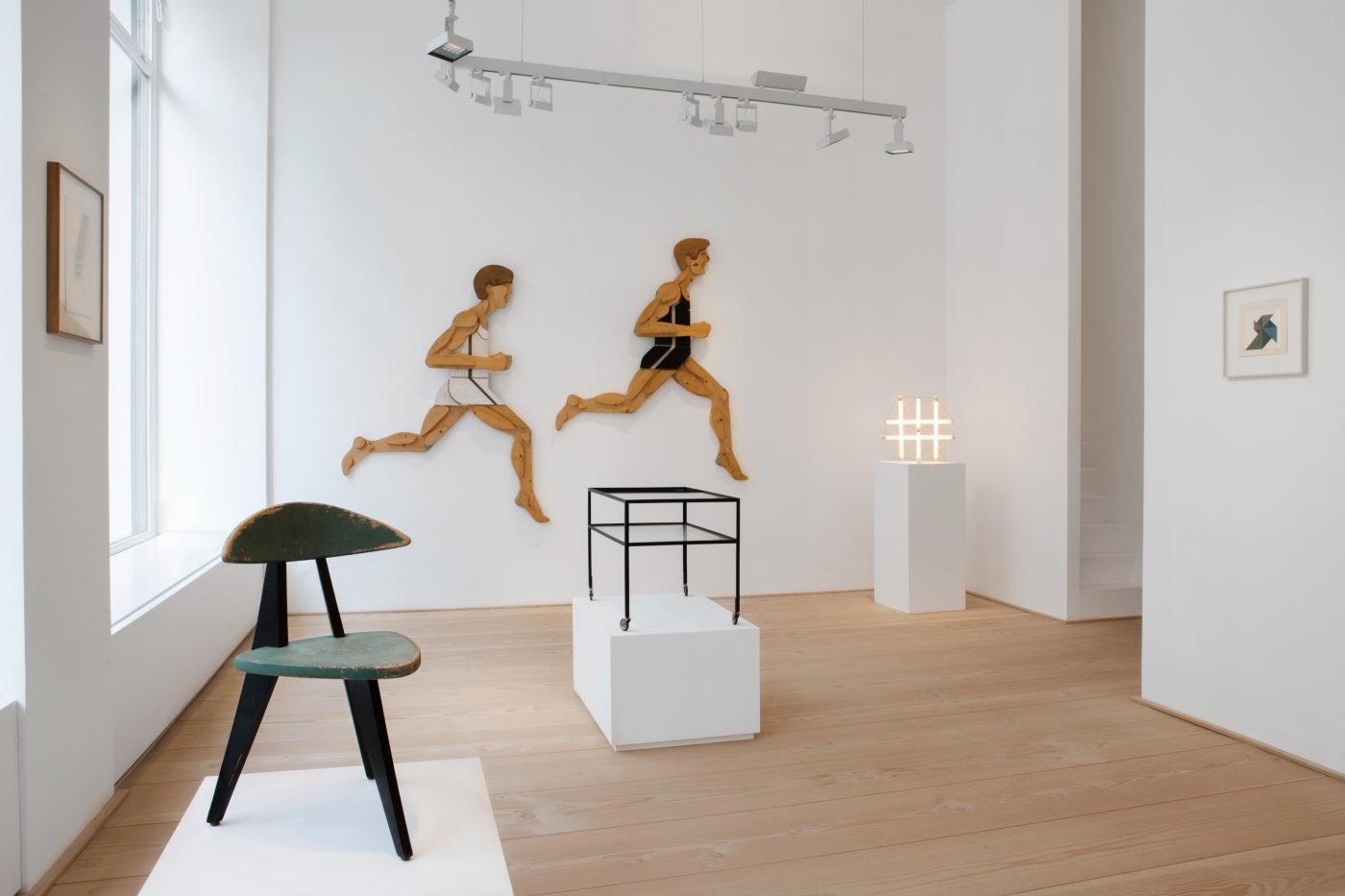 From left, a children's three-legged chair by WALTER PAPST, a pair of OTL AICHER wall sculptures, a HERBERT HIRCHE SERVING CART, an INGO MAURER lamp and an ANTON STANKOWSKI PAINTING