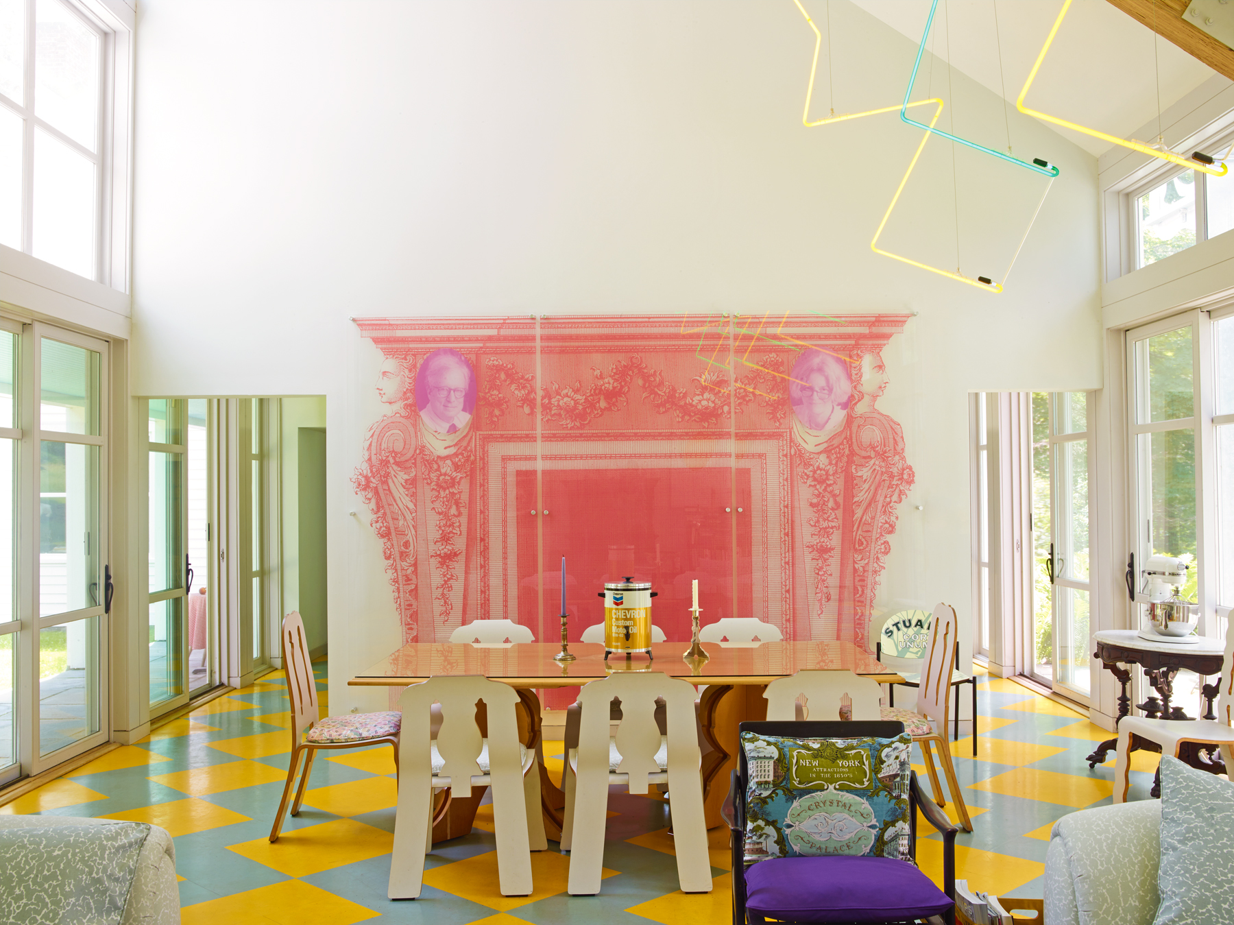 Dining area designed by artist Cary Leibowitz and creative director Simon Lince, featuring colorful furniture and decorations