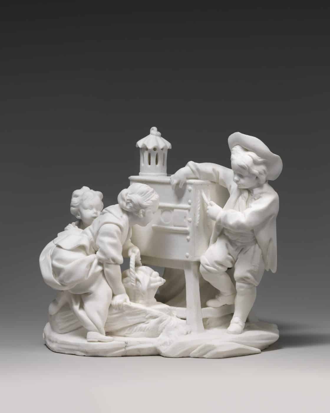 A ca. 1760 porcelain figurine, produced in the Sèvres manufactory, outside Paris, shows two girls viewing a magic lantern