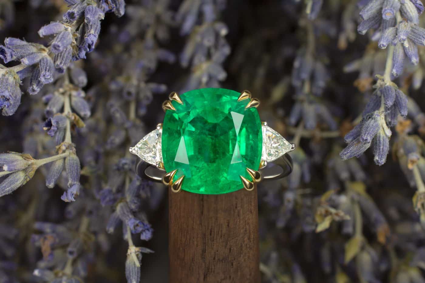 6.60-carat cushion-cut emerald ring with trillion cut diamonds on either side