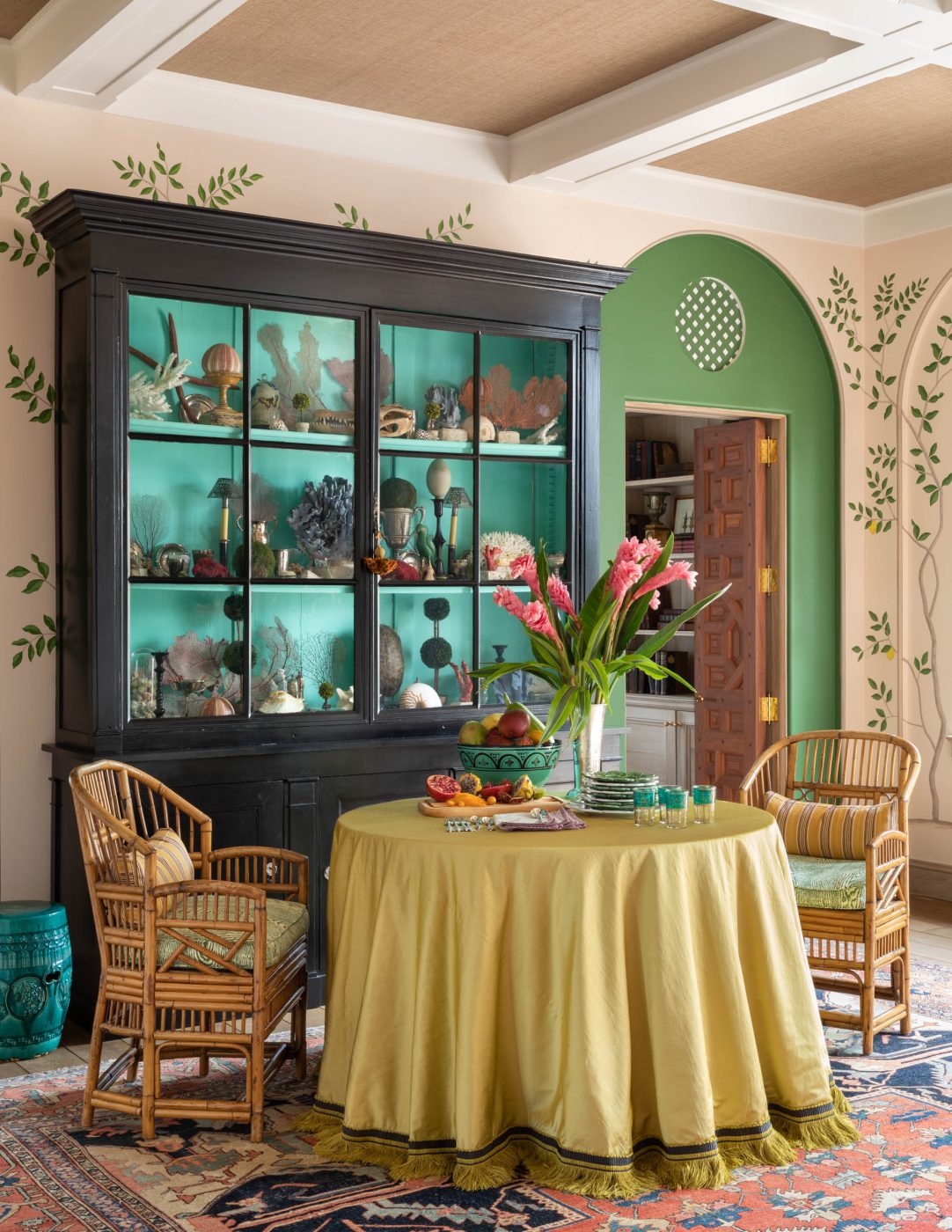 Photo of the family room that features a black vintage cabinet and vintage bamboo and rattan chairs