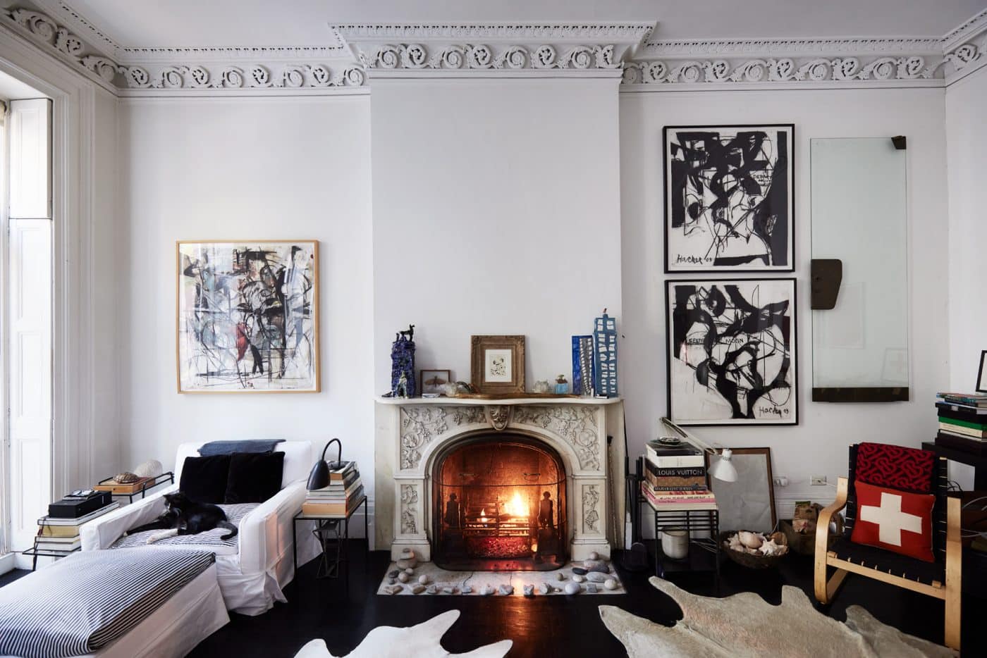 Tonne Goodman's living room with a working fireplace, unique rugs, and eye-catching art