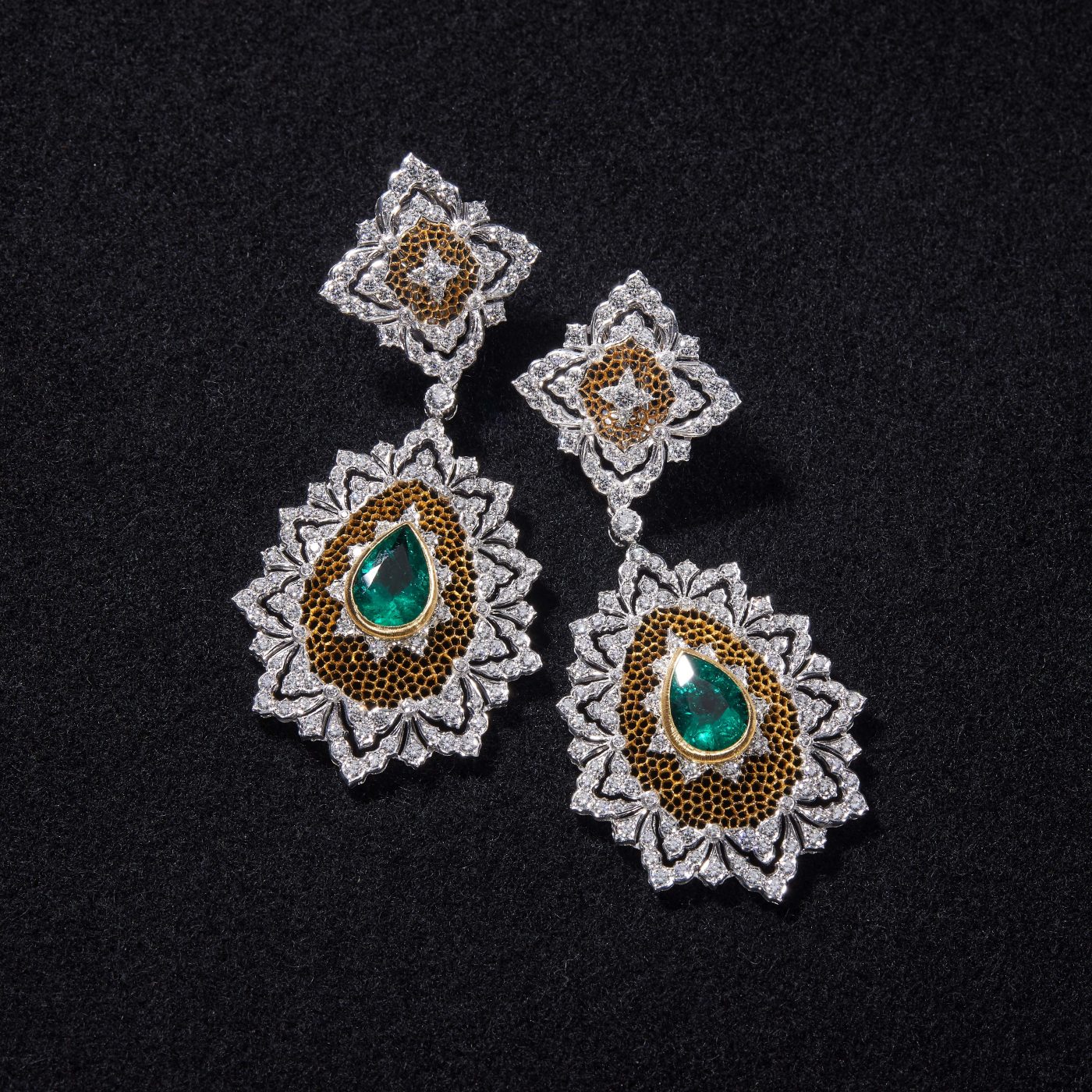 White- and yellow-gold honeycomb pendant earrings set with emeralds and diamonds.