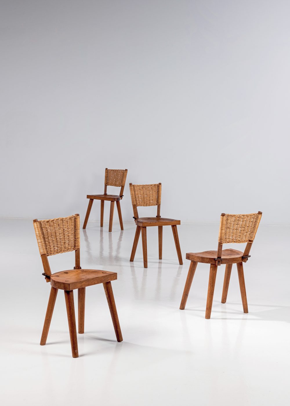 circa 1955 oak and wicker chairs by Les Artisans de Marolles