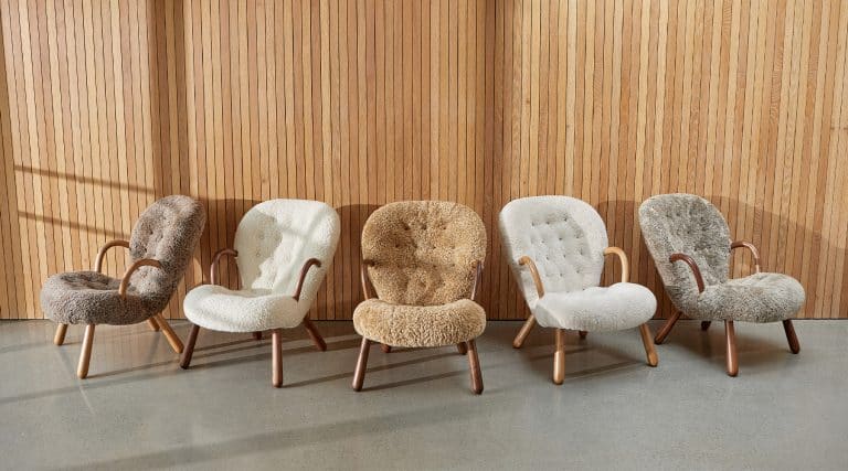 Five reeditioned Arnold Madsen Clam chairs with sheepskin upholstery in a range of neutral colors