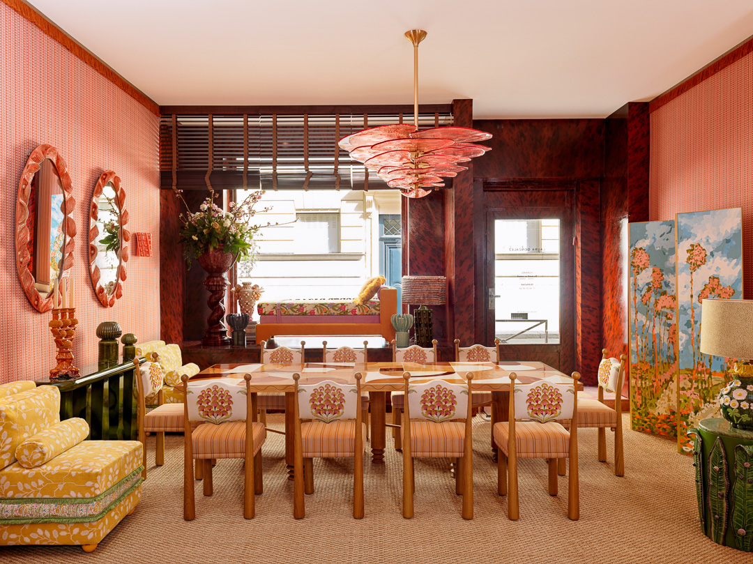 A photo of the gallery, featuring a large dining table and colorful furniture