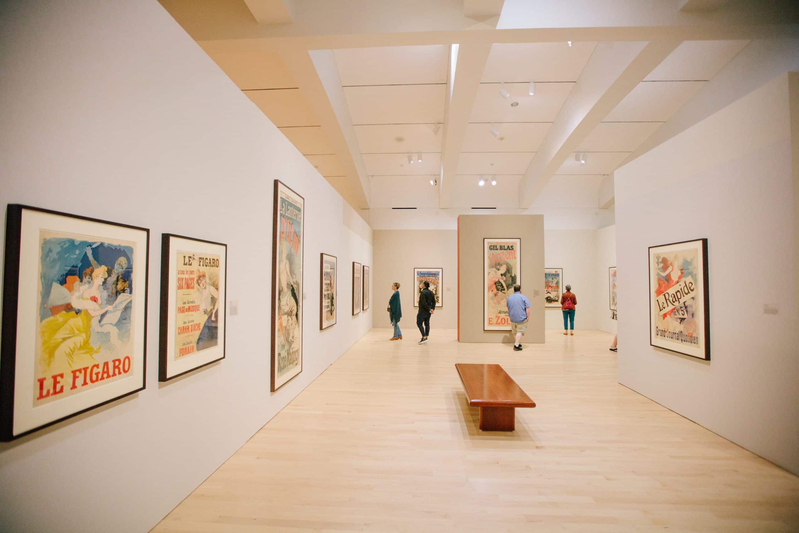 Museumgoers peruse the posters in “Always New: The Posters of Jules Chéret” at Milwaukee Museum of Art