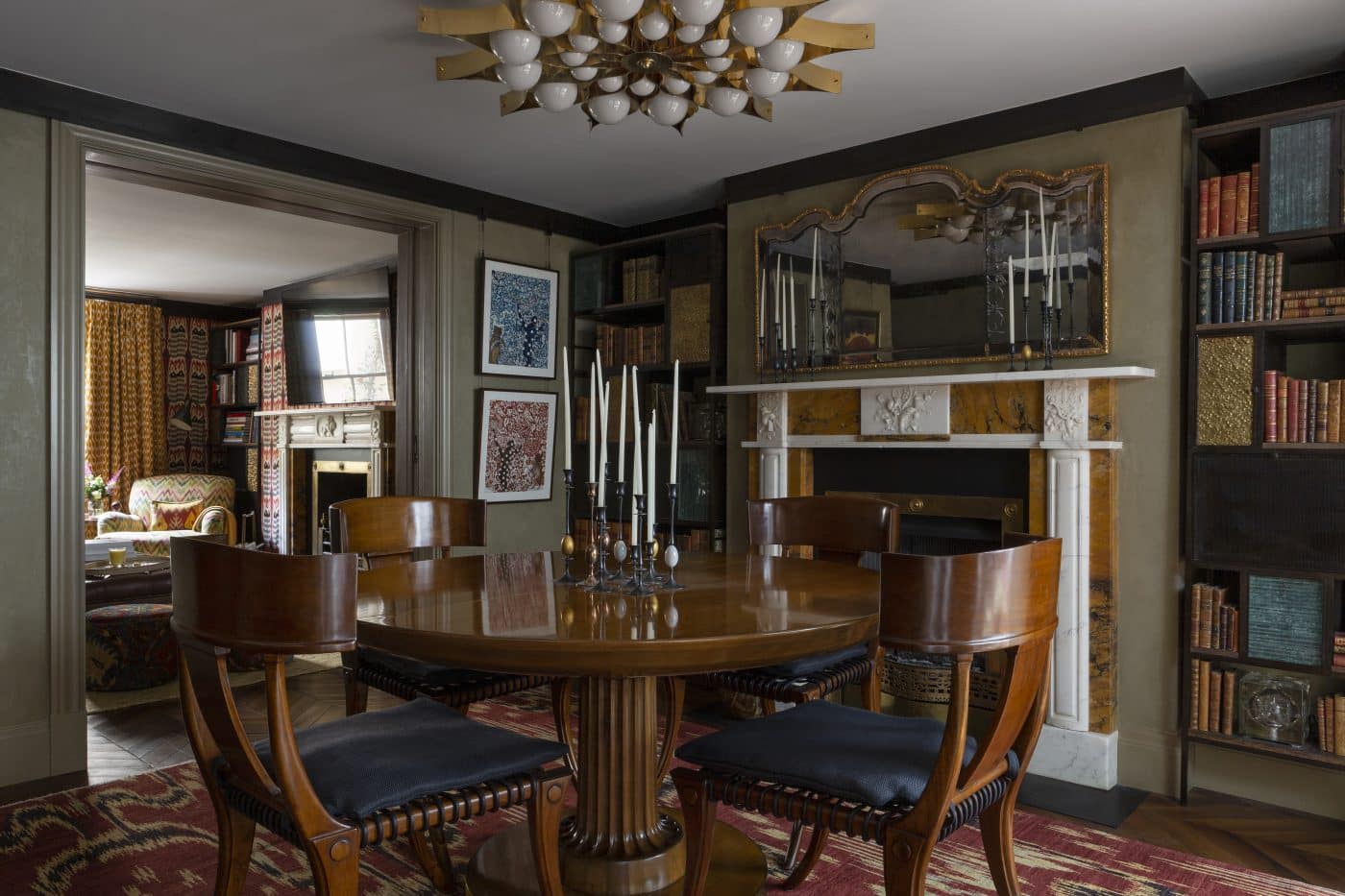 Dining room of townhouse in London's Knightsbridge designed by Bryan O'Sullivan with klismos chairs, Gio Ponti chandelier, Jamb mantel, T.H. Robsjohn-Gibbings table