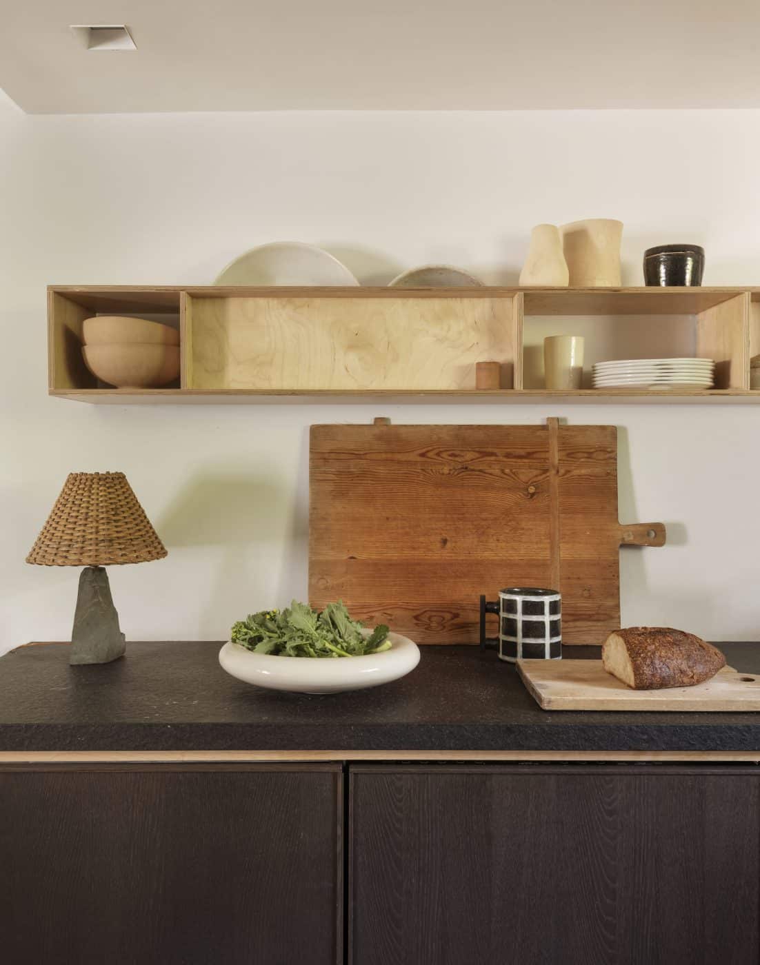 Andy Baraghani's countertop with vintage French lamp and wooden cutting board