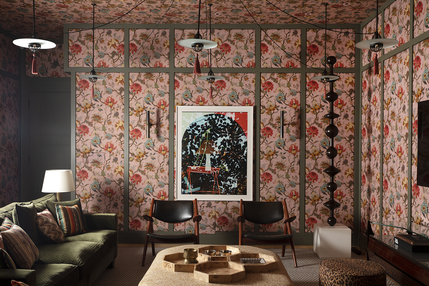 TV room of townhouse in London's Chelsea neighborhood designed by Bryan O'Sullivan with floral House of Hackney pink wallpaper, Hans Wegner chairs, Silvio Cavatorta rosewood sideboard