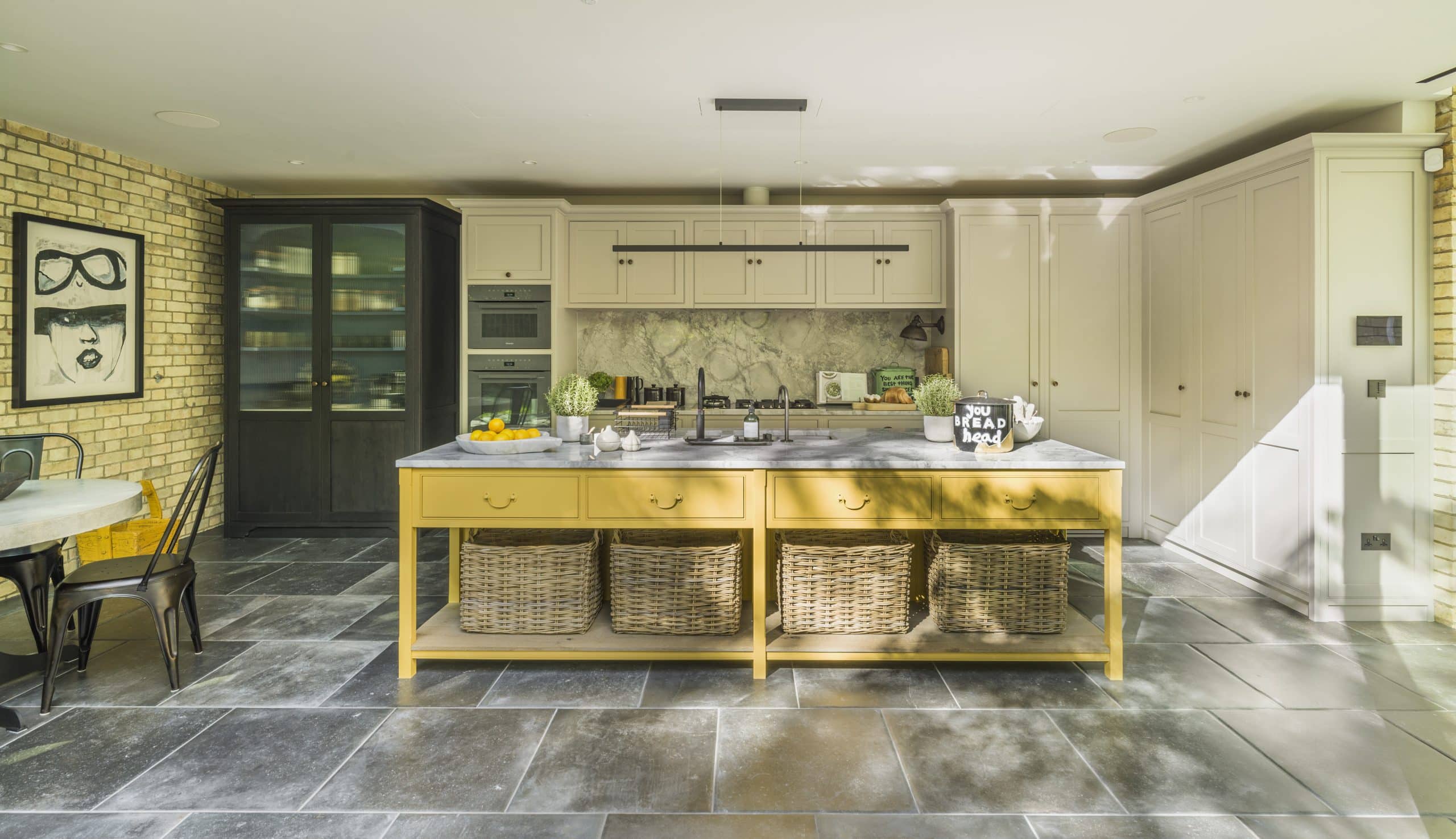 Boy George's farmhouse-style kitchen with yellow island