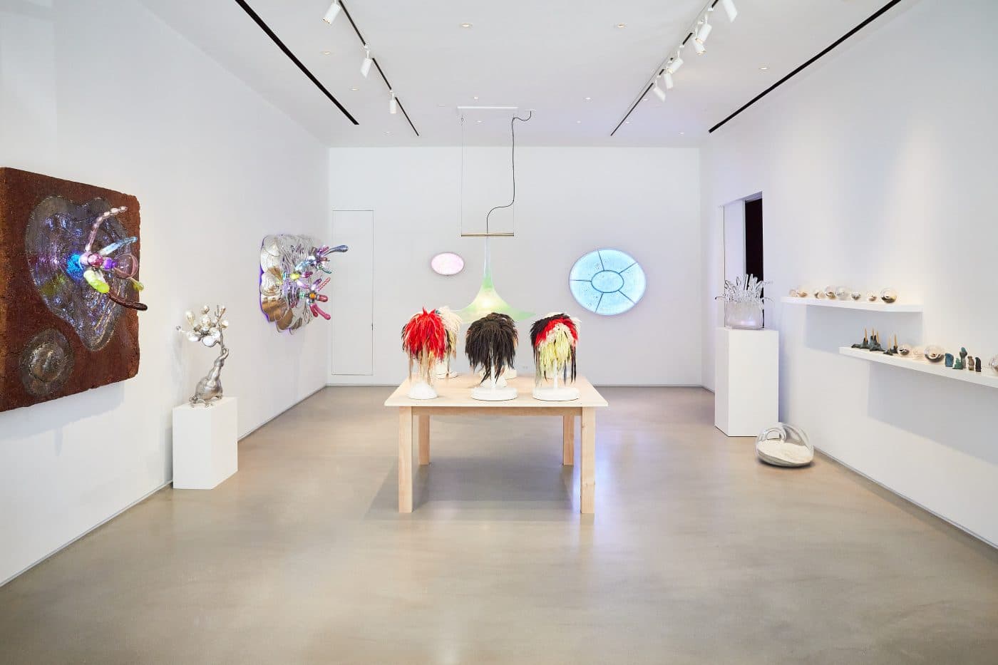 Sculptures from Paula Haye's "Warriors" series, resembling multicolor wigs, made with handspun wool, yak hair 