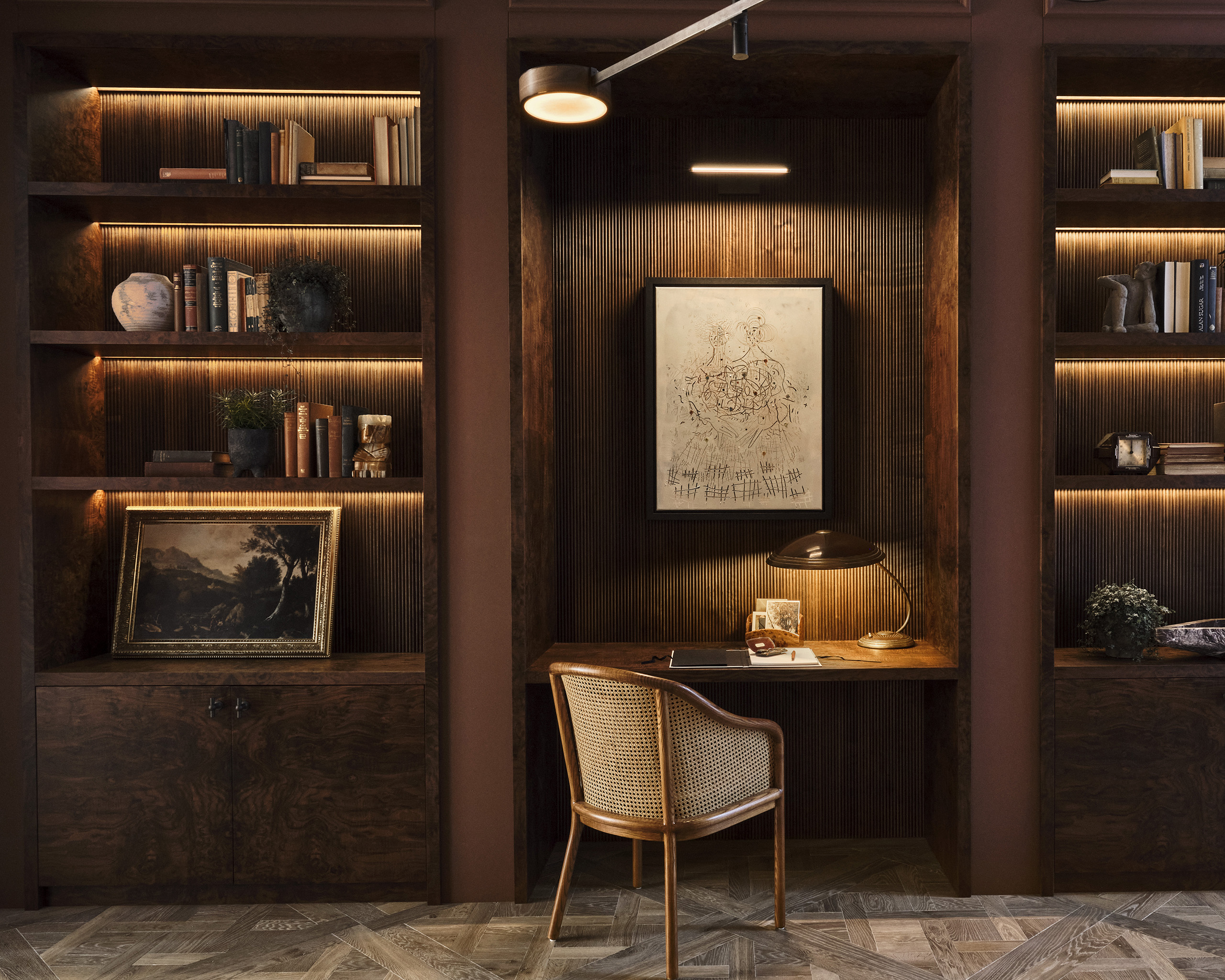Banda interior design studio chelsea London dark wood-paneled study with built-in desk and shelves