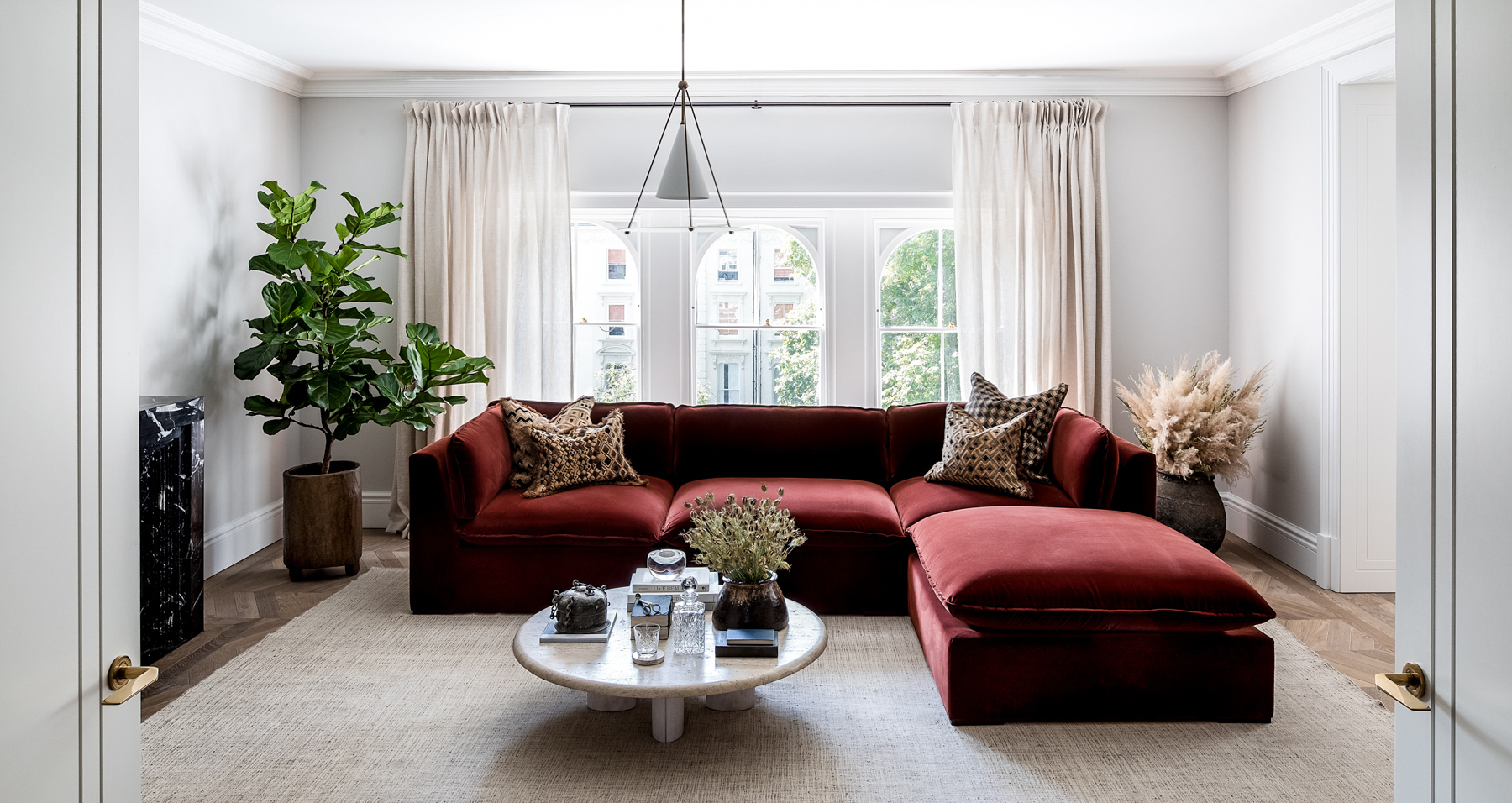 Banda interior design studio West London apartment living room with large deep red sectional sofa