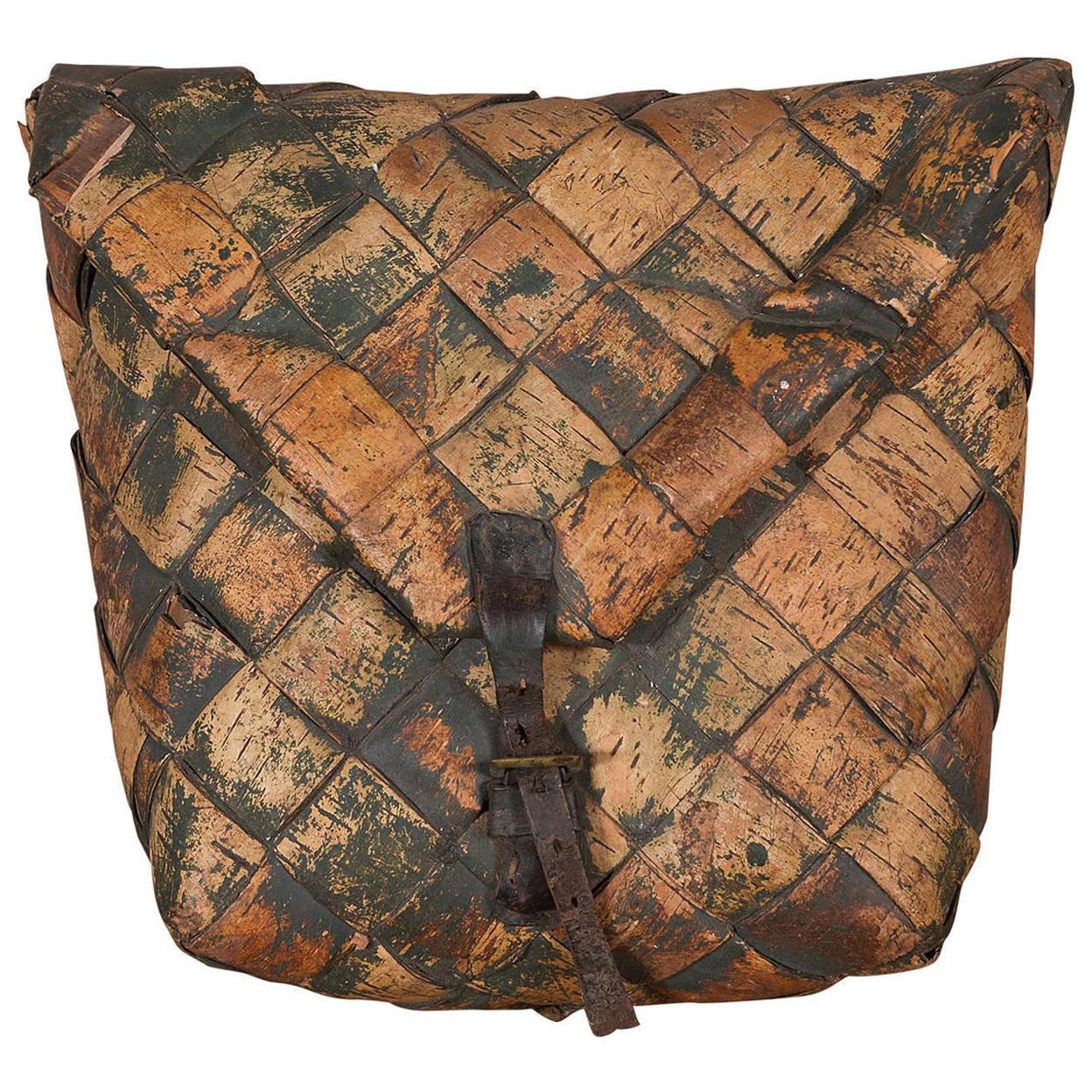 An early-20th-century SWEDISH FRUIT BASKET, shaped like a pouch with a buckled flap 