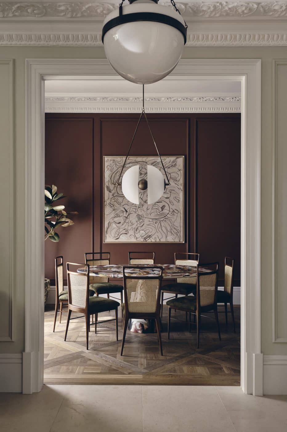 Banda interior design studio chelsea London dining room with 8 chairs at rount table under pendant light  