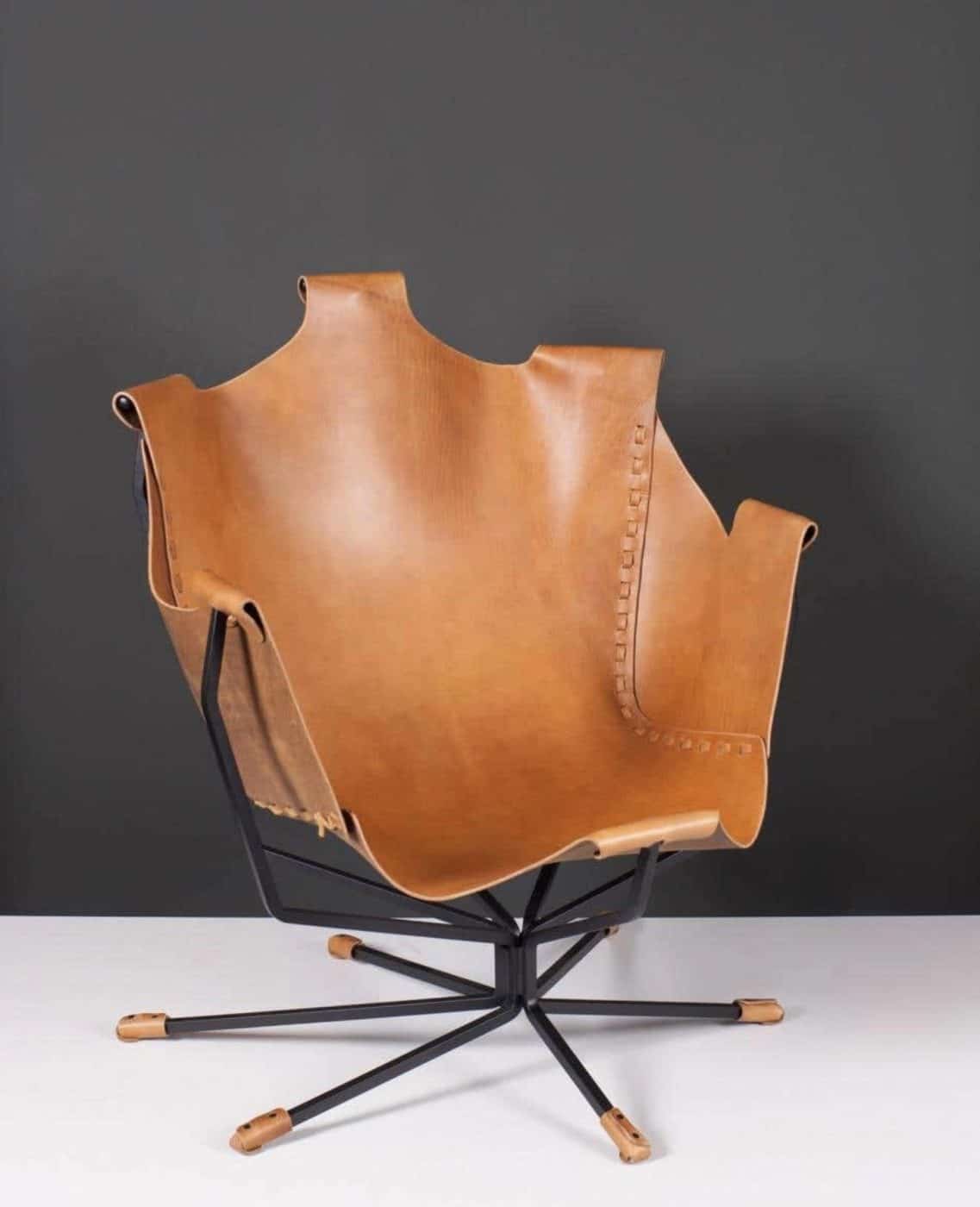 A cognac-colored leather chair with a black steel frame